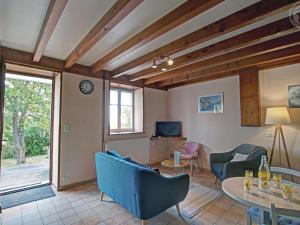 a living room with blue chairs and a table at Gîte Les Hortensias à Pralong - Charme et Confort pour 4 Pers avec Internet - FR-1-496-117 in Pralong