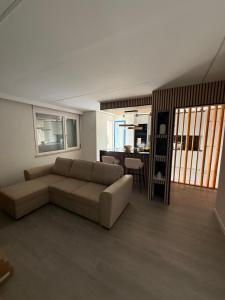 a living room with a couch and a kitchen at Casa Noir Luxury 3BR Apartment 2 Baths Near Lisbon & Sintra in Queluz