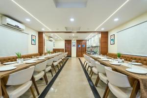 a conference room with tables and chairs and a whiteboard at Treebo Landmark in Visakhapatnam