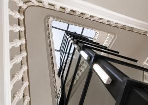 a mirror on the side of a stairway at Hotel Casa Gardenia by Blossom Hotels in Barcelona