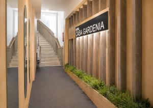 a sign on the side of a building with stairs at Hotel Casa Gardenia by Blossom Hotels in Barcelona