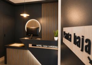 a room with a desk with a tv on a wall at Hotel Casa Gardenia by Blossom Hotels in Barcelona