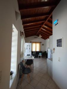 a living room with a table and chairs at DiPo's Beachside House with Sea View in Samos