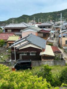 a truck parked in front of a group of houses at ゲストハウス奥白浜 in Shirahama +8 photos