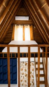 a bed in a wooden attic with a window at Sheen Coast Beach Cabana in Nilaveli