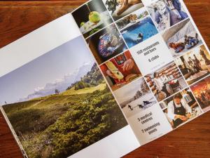 a page of a brochure on a wooden table at Apartment Terrasse Des Alpes 708 by Interhome in Vermala