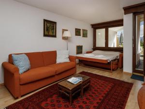 a living room with a couch and a bed at Studio Terrasse Des Alpes 618 by Interhome in Crans-Montana