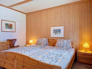 a bedroom with a large bed with wooden walls at Apartment Chalet Almis 5 by Interhome in Grindelwald +34 photos