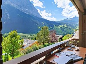 a balcony with a table and a view of a mountain at Apartment Chalet Almis 5 by Interhome in Grindelwald