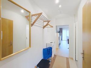 a bathroom with a mirror and a blue chair at Apartment Allod Park Haus B 202 by Interhome in Davos