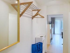 a white room with a mirror and a hallway at Apartment Allod Park Haus B 202 by Interhome in Davos