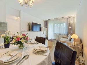 a dining room with a table and a living room at Apartment Allod Park Haus B 202 by Interhome in Davos +43 photos