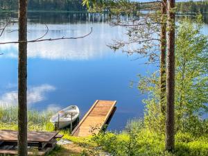 a boat on a dock next to a lake at Holiday Home Harjula by Interhome in Nissi