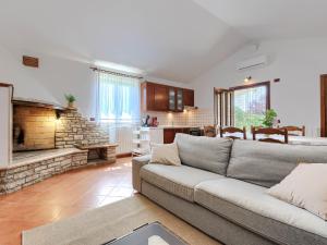 a living room with a couch and a fireplace at Holiday Home Tomazin by Interhome in Pazin