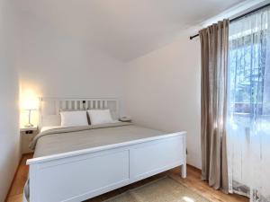 a white bedroom with a white bed and a window at Holiday Home Tomazin by Interhome in Pazin +45 photos