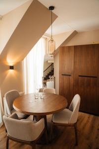 a dining room with a wooden table and chairs at Castle Hill Residence in Karlovy Vary