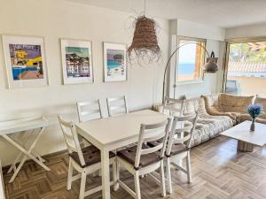 a living room with a table and chairs and a couch at Apartment Cadet Rousse-6 by Interhome in Le Lavandou +21 photos