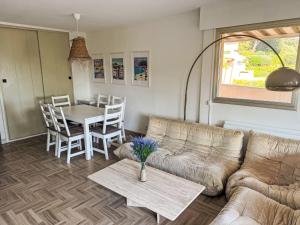 a living room with a couch and a table at Apartment Cadet Rousse-6 by Interhome in Le Lavandou