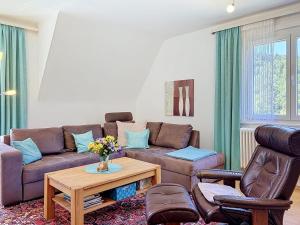 a living room with a couch and a table at Apartment Maier-2 by Interhome in Triberg