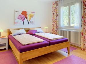 a bedroom with a bed with a purple mattress at Apartment Maier-2 by Interhome in Triberg