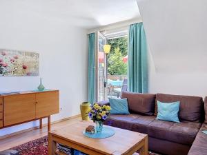 a living room with a brown couch and a table at Apartment Maier-2 by Interhome in Triberg
