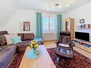 a living room with a couch and a table at Apartment Maier-2 by Interhome in Triberg +17 photos