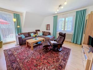 a living room with a couch and a table at Apartment Maier-2 by Interhome in Triberg