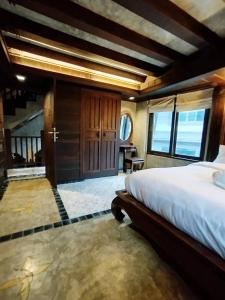 a bedroom with a large bed in a room at Five Star Guest house in Chiang Mai