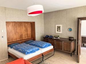 a bedroom with a bed and a wooden headboard at Apartment Pavillon Castagneto by Interhome in Castasegna