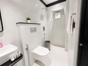 a white bathroom with a toilet and a sink at NEAR SHREE RAM JANM BHOOMI - HOTEL SHREE RR - Wi-Fi - Parking- Luxury Rooms - Best Family Hotel In Ayodhya in Ayodhya