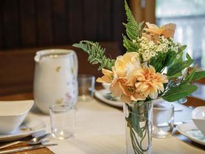 a vase filled with flowers sitting on a table at Apartment Chalet L'Aube by Interhome in Vers L'Eglise