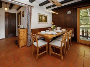 a dining room with a wooden table and chairs at Apartment Chalet L'Aube by Interhome in Vers L'Eglise +26 photos