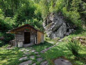 a small wooden cabin with flowers on the door at Apartment Chalet L'Aube by Interhome in Vers L'Eglise