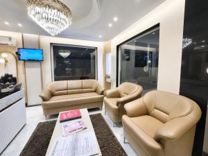 a waiting room with two chairs and a table at NEAR SHREE RAM JANM BHOOMI - HOTEL SHREE RR - Wi-Fi - Parking- Luxury Rooms - Best Family Hotel In Ayodhya in Ayodhya