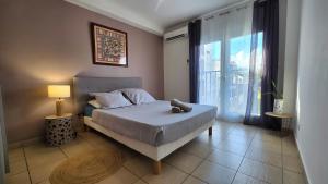 a bedroom with a bed with a stuffed animal on it at L'Arymarius 12 in Saint-Pierre