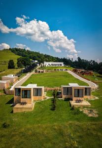 a group of modular homes on a green field at Moon Valley Comarnic in Sinaia