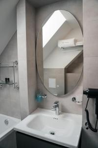 a bathroom with a sink and a mirror at Castle Hill Residence in Karlovy Vary +61 photos