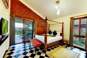 a bedroom with a bed and a balcony at Indo Asia Heritage Coorg, formerly Heritage Resort Coorg in Madikeri