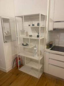 a kitchen with white shelves in a white kitchen at 16 zeros villa in Paralia Katerinis