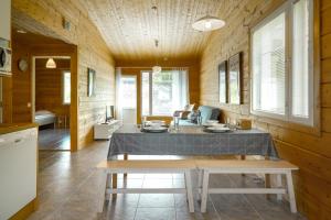 a dining room with a table in a wooden house at Apartment A 3 Talja, Private Sauna By Lapland Host in Rovaniemi