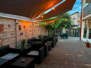 an outdoor patio with couches and plants and lights at Gemini House ULTRACENTRAL 3 margarete in Costinesti