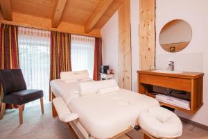a room with a bed and a mirror and a sink at Luxus Suite mit Whirlpool im Hotel Rupertihof in Ainring +95 photos