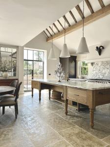 a kitchen with a large wooden table in a room at Surrey Barn, Newly Renovated in Ripley