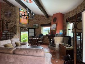 a living room with a couch and a table at BLEU MAISON-PAZO 2 CL in Campo Lameiro