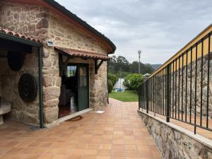 a porch of a stone house with a fence at BLEU MAISON-PAZO 2 CL in Campo Lameiro