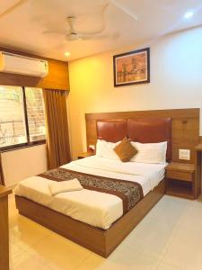 a bedroom with a large bed in a room at Crystal Luxury Hotel in Mumbai