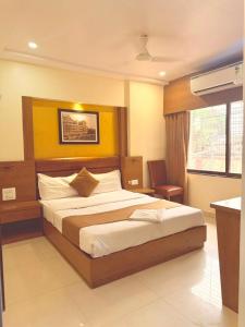 a bedroom with a large bed in a room at Crystal Luxury Hotel in Mumbai