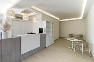 an office with a counter and a table and chairs at Affittacamere Mare Poetto Cagliari in Quartu Sant'Elena