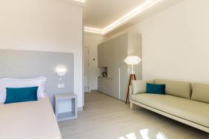a living room with a bed and a couch at Affittacamere Mare Poetto Cagliari in Quartu Sant'Elena +24 photos