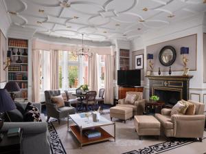 a living room filled with furniture and a fireplace at 11 Cadogan Gardens and The Apartments in London
